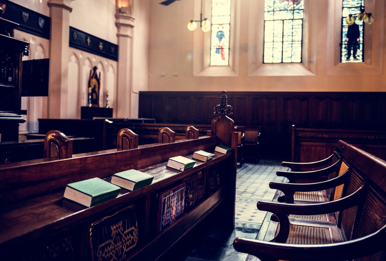 Empty wooden pews inside historic courtroom or church with stained glass windows {{brizy_dc_image_alt entityId=