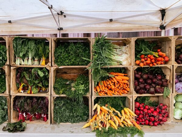 Crates of fresh vegetables displayed at a local market stall